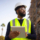 A young black man is a project manager at a residential construction site.