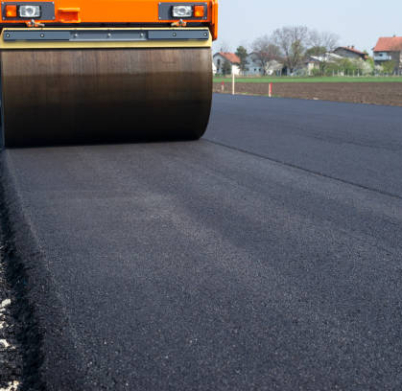 Machine flattening new layer of asphalt. Road construction.