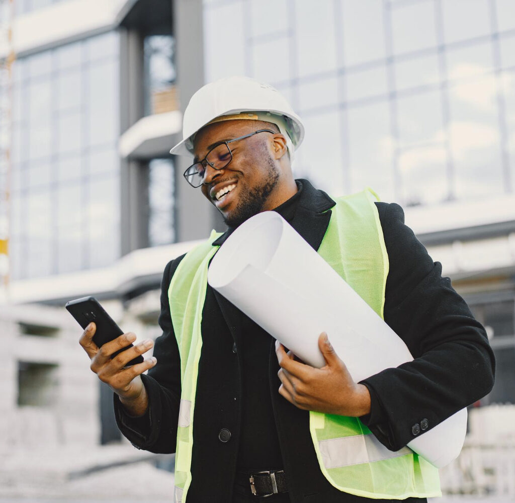 young-black-race-man-with-blueprint-stading-near-glass-building